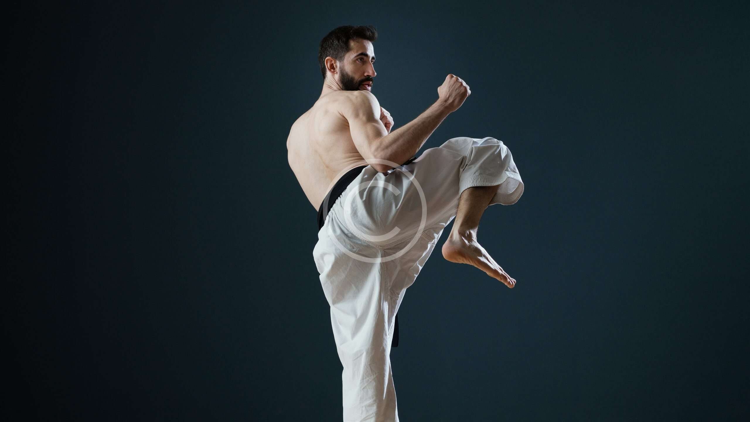 Young man is practicing martial arts in sport